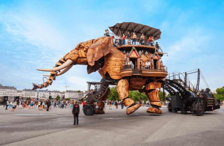 a large wooden elephant with people on it